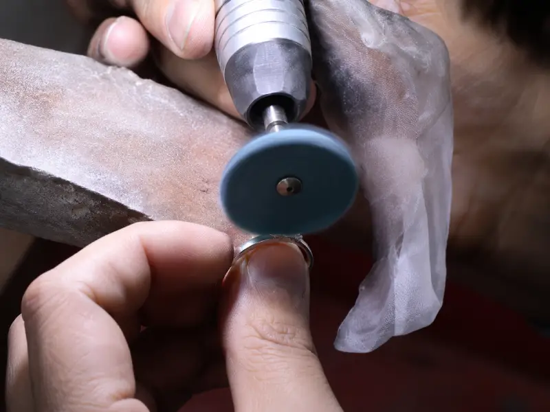 Jeweler polishing a jewelry ring