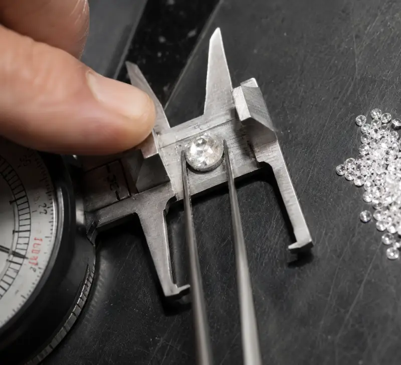 Jewelry stones being measured and selected