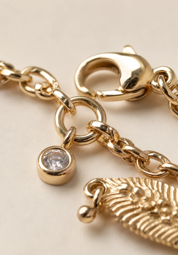 Detailed view of bracelet chain links, jump rings, clasp connectors, and charm attachment points