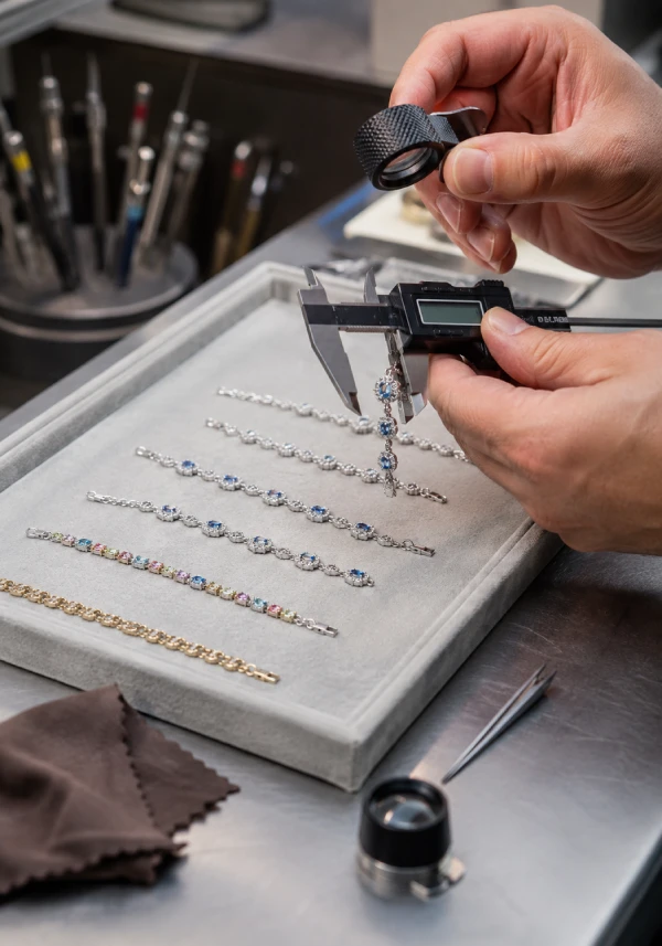 Jewelry quality inspector checking custom bracelet length, clasp, chain links, and surface finish