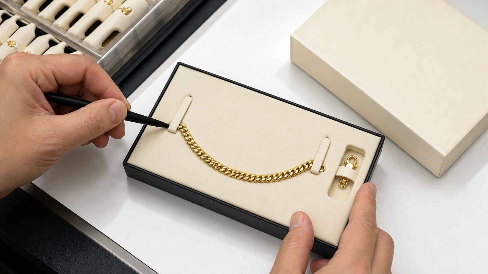 Technician testing bracelet retention and clasp isolation in a packaging insert