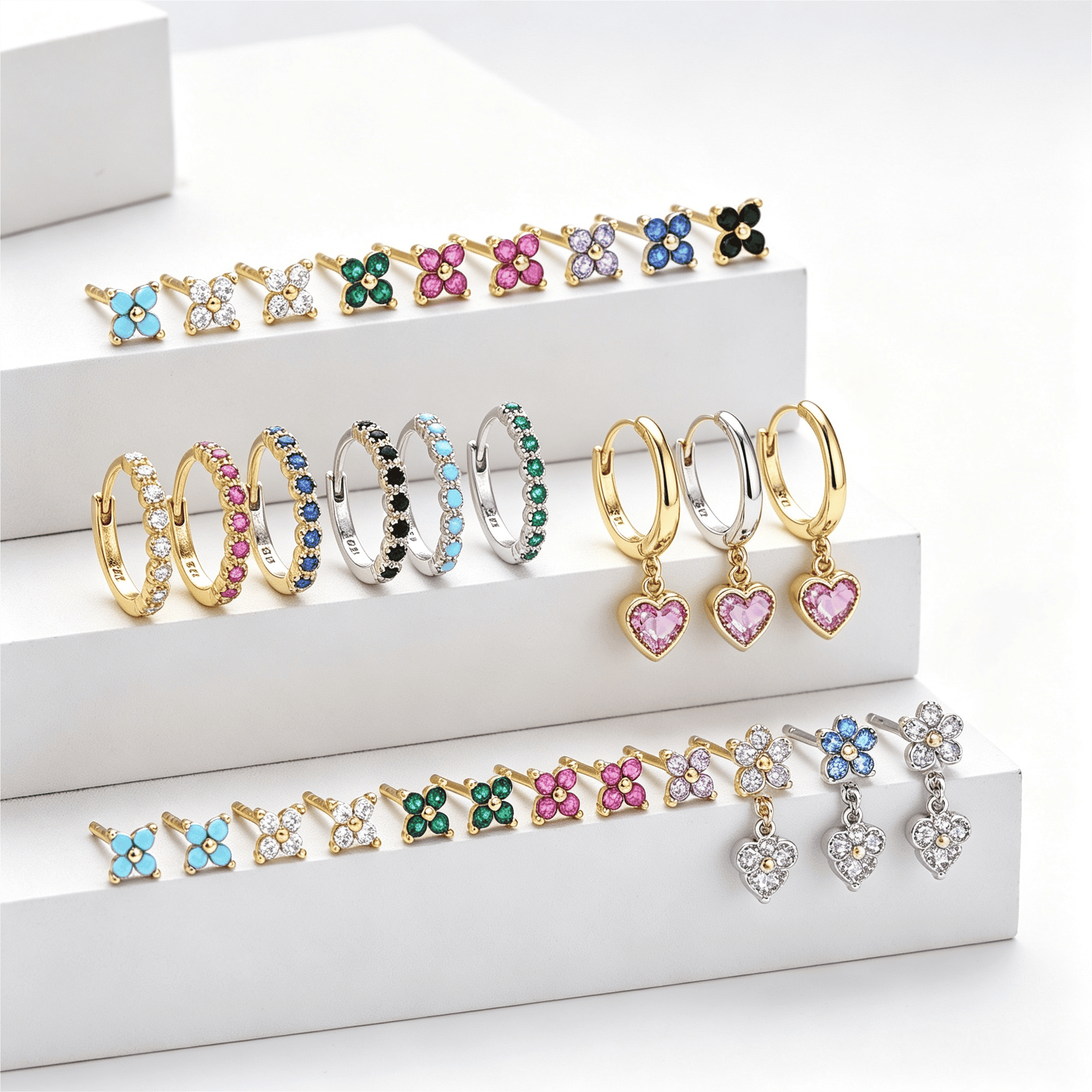 Custom 18K gold jewelry samples in yellow, white and rose gold with rings, pendants and earrings